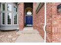 Elegant front door with brick columns and landscaping at 12527 Tapadero Way, Castle Pines, CO 80108