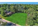 Large vacant lot surrounded by mature trees and homes at 755 S Jackson St, Denver, CO 80209