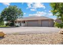 House exterior on a sunny day with a three-car garage and landscaped yard at 11685 Salem St, Henderson, CO 80640