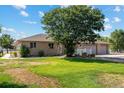 House exterior on a sunny day with a three car garage and a landscaped yard at 11685 Salem St, Henderson, CO 80640