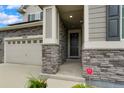 Front entrance with stone accents and a black door at 25163 E Byers Dr, Aurora, CO 80018