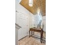 Bright entryway with mirror, console table, and staircase leading upstairs at 13042 Grant E Cir # C, Thornton, CO 80241