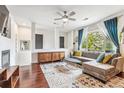 Living room features hardwood floors, fireplace, and ample natural light at 13042 Grant E Cir # C, Thornton, CO 80241