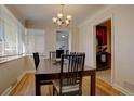 Dining room with hardwood floors and view into the kitchen at 2812 Krameria St, Denver, CO 80207