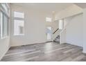 Open living room with stairs and lots of natural light at 1244 S Algonquian St, Aurora, CO 80018