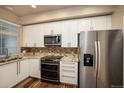 Modern kitchen with white cabinets, granite countertops and stainless steel appliances at 4508 E Louisiana Ave, Denver, CO 80246