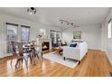 Bright living room features hardwood floors, fireplace, and ample natural light at 10108 E 31St Ave, Denver, CO 80238