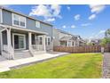 Home's backyard, featuring a patio and grassy area at 26346 E Canal Pl, Aurora, CO 80018