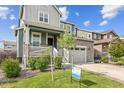 Two-story house with a gray and teal exterior at 26346 E Canal Pl, Aurora, CO 80018