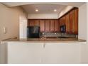 Kitchen features granite counters and breakfast bar at 2500 E Cherry Creek South Dr # 414, Denver, CO 80209