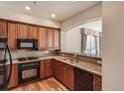 Modern kitchen with granite countertops and wood cabinets at 2500 E Cherry Creek South Dr # 414, Denver, CO 80209