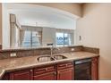 Kitchen with granite countertops, breakfast bar, and view to living area at 2500 E Cherry Creek South Dr # 414, Denver, CO 80209