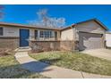 Brick front home with walkway leading to the entrance at 3417 S Chester Ct, Denver, CO 80231