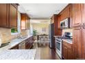 Bright kitchen with granite countertops and stainless steel appliances at 470 S Kingston Cir, Aurora, CO 80012