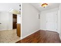 Entryway with hardwood floors, a view of the kitchen, and a white door at 13901 E Marina Dr # 109, Aurora, CO 80014