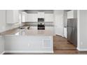 Modern kitchen features granite countertops, white cabinets, and stainless steel appliances at 2224 Alyssa St, Fort Lupton, CO 80621