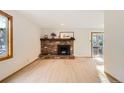 Living room featuring a brick fireplace and patio access at 4888 Silver Spruce Ln, Evergreen, CO 80439