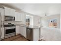 Open concept kitchen with island and stainless steel appliances at 1004 Savona Ave, Fort Lupton, CO 80621