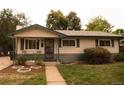 Ranch-style home with landscaped yard and walkway at 6213 Gray St, Arvada, CO 80003