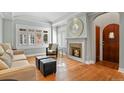 Living room with hardwood floors, fireplace, and seating at 1529 Holly, Denver, CO 80220