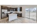 Modern kitchen with stainless steel appliances and an island at 4703 Thistle Dr, Brighton, CO 80601