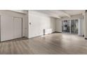 Living room with hardwood floors and sliding glass door to balcony at 1265 Race St # 208, Denver, CO 80206