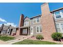 Two-story townhouse exterior with brick and gray siding at 16941 E Chenango Ave # C, Aurora, CO 80015