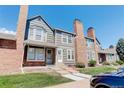 Townhouse exterior, brick and gray siding, front walkway at 16941 E Chenango Ave # C, Aurora, CO 80015