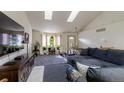Spacious living room with vaulted ceilings, comfy sectional sofa, and large TV at 2617 E Egbert St, Brighton, CO 80601