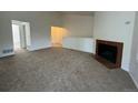 Living room with fireplace and a half-wall separating it from the kitchen at 11479 E 1St Ave, Aurora, CO 80010