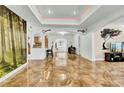 Bright living room with tile floors, large artwork, and a modern TV stand at 1219 Tucson St, Aurora, CO 80011