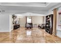 Living room featuring two leather sofas, a coffee table, and tile floors at 1219 Tucson St, Aurora, CO 80011