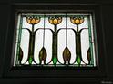 Close-up of a beautiful stained-glass window with a floral design at 1053 N Colorado Blvd, Denver, CO 80206