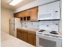 Efficient galley kitchen with wood cabinets and appliances at 1020 15Th St # 37I, Denver, CO 80202