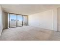 Spacious living room with wall-to-wall carpet and sliding glass door to balcony at 1020 15Th St # 37I, Denver, CO 80202