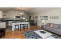 Open floor plan with hardwood floors, modern kitchen, and comfy living area at 4542 Sheridan Blvd, Denver, CO 80212