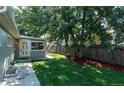 Side yard with mature tree, wood fence, and walkway at 4542 Sheridan Blvd, Denver, CO 80212