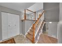 Inviting entryway with tiled flooring, staircase, and coat closet at 8160 W 81St Pl, Arvada, CO 80005