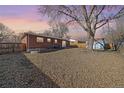 Large backyard with a spacious lawn and a storage shed at 6896 Newcombe St, Arvada, CO 80004