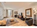 Living room with hardwood floors, fireplace, and comfortable seating at 1705 Gaylord St # 107, Denver, CO 80206
