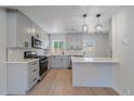 Modern kitchen with gray cabinets, quartz countertops, and stainless steel appliances at 3738 N Eliot St # 3, Denver, CO 80211