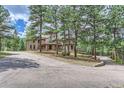Long driveway leading to a stunning two-story house at 26600 Mowbray Ct, Evergreen, CO 80439