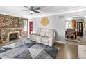 Spacious living room with a stone fireplace and hardwood floors at 2371 Locust St, Denver, CO 80207