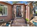 Ornate front door entrance with brick columns and stone steps at 2371 Locust St, Denver, CO 80207