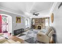 Living room with stone fireplace, hardwood floors, and lots of natural light at 2371 Locust St, Denver, CO 80207