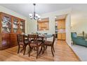 Bright dining area with wood flooring, a wooden table and chairs, and kitchen views at 660 S Alton Way # 3B, Denver, CO 80247