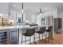 Modern kitchen with a large island and stainless steel appliances at 4244 E 8Th Pl, Denver, CO 80220