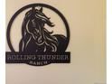 Metal sign with the words Rolling Thunder Ranch at 7846 Village Rd, Parker, CO 80134