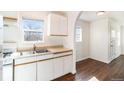 Cozy kitchen with white cabinets, double sink, and gas range at 1565 Xanthia St, Denver, CO 80220