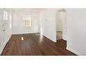 Bright living room featuring hardwood floors and an arched doorway at 1565 Xanthia St, Denver, CO 80220